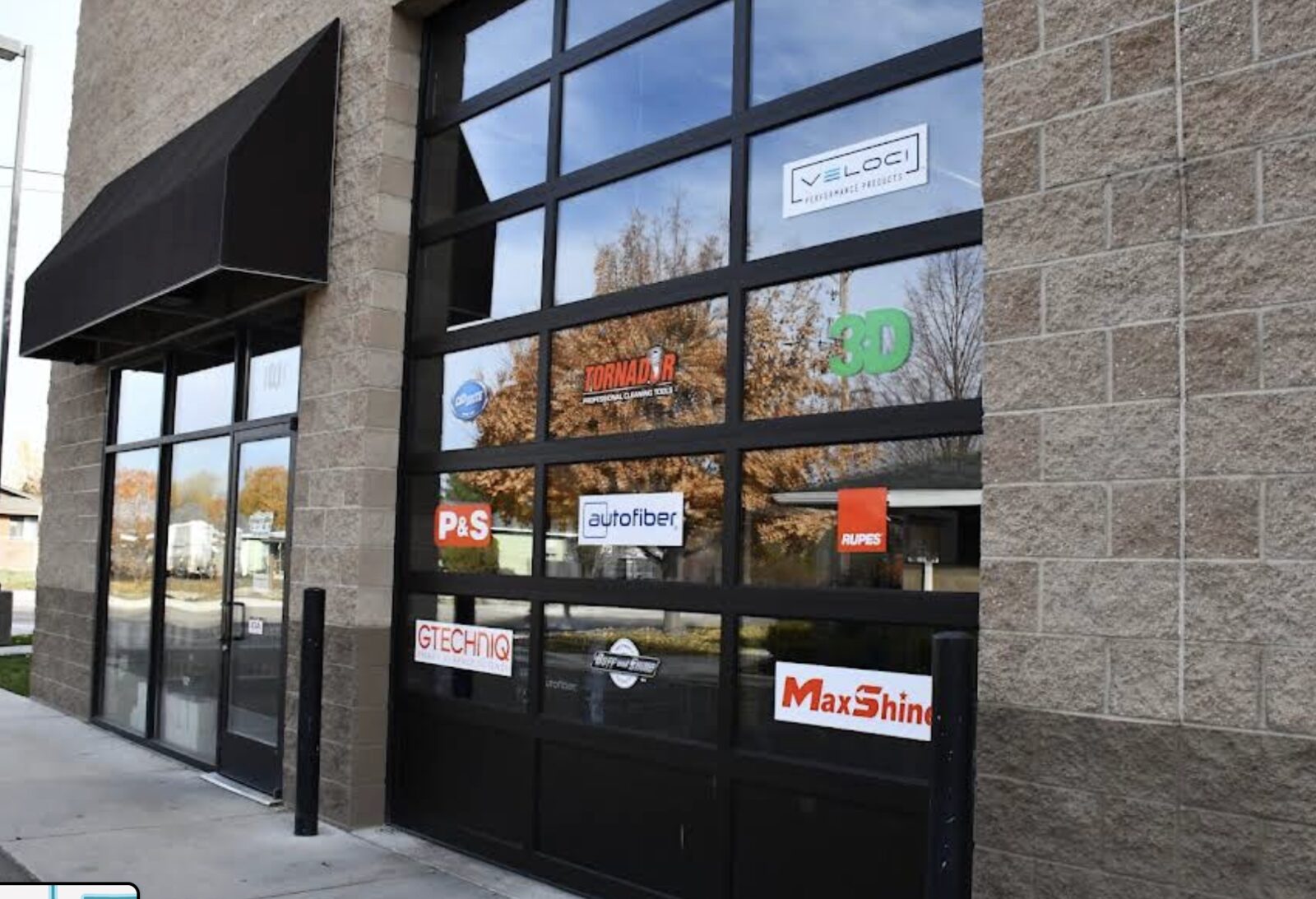 Specialty Supply storefront bay door with brand decals in Meridian