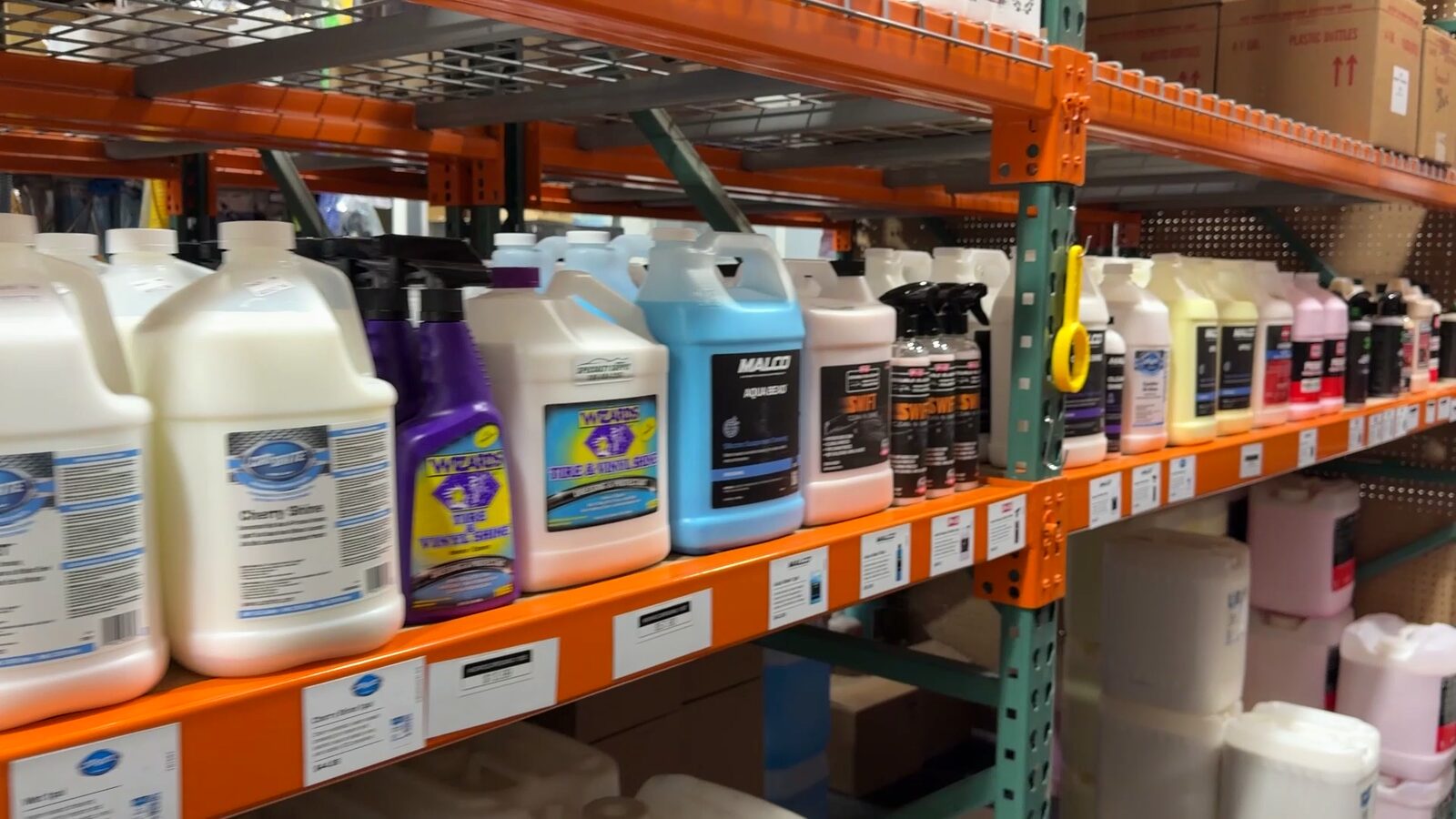 Stocked gallon chemical aisle at the Specialty Supply warehouse